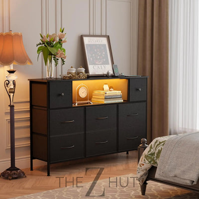 Fixwal Dresser for Bedroom with Power Outlets and LED Lights, Black 55" TV Stand with 8 Drawers, Fabric Chest of Drawers with PU Finish for Living Room, Entryway THE Z HUT